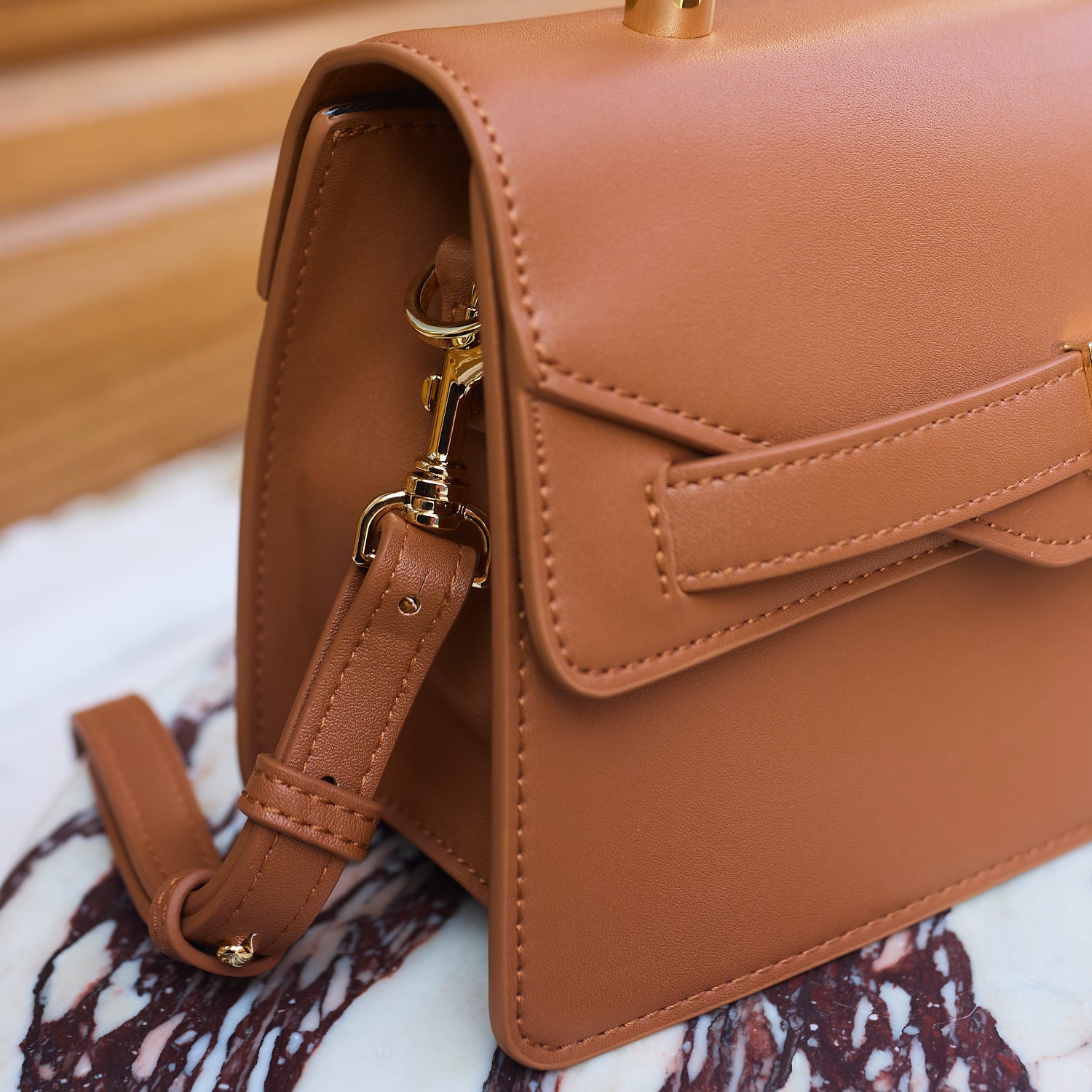 Pippa handbag with gold hardware and shoulder strap.